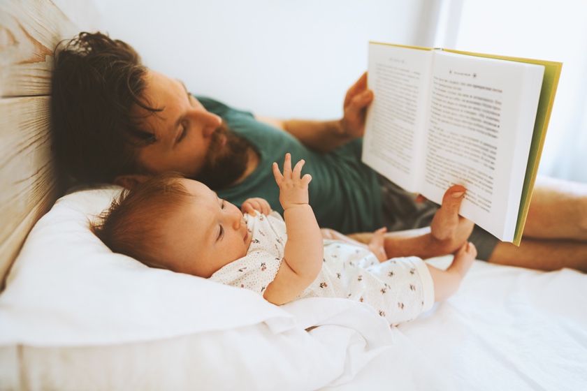 Man reading a book to a child