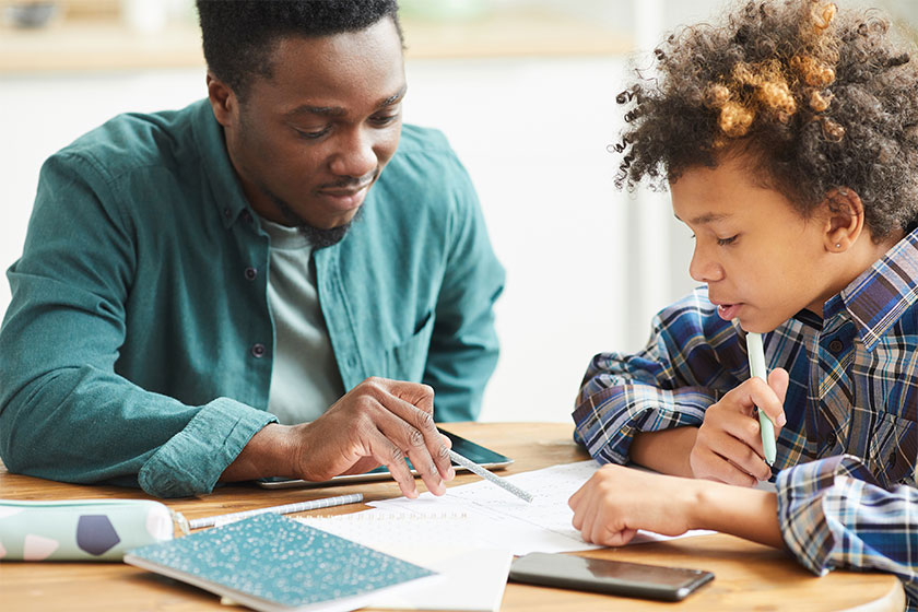 Man helping his son with homework