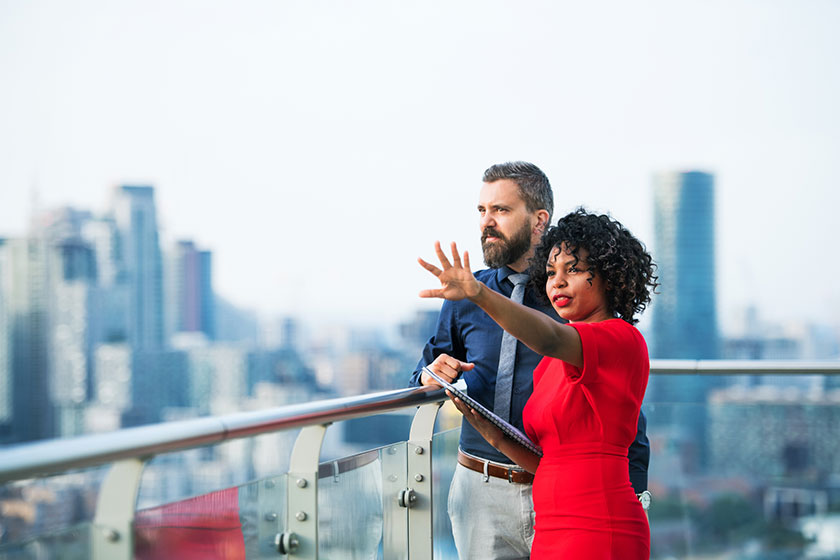 Man and woman looking at cityscape