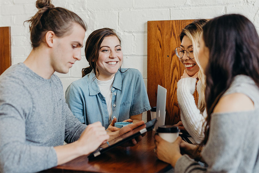 Four young people sat around a table