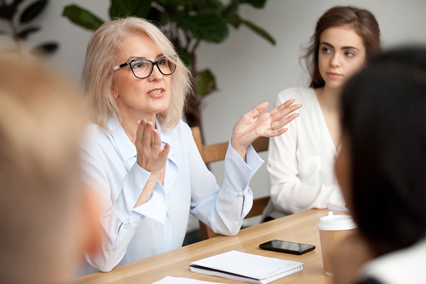 Older woman leading meeting