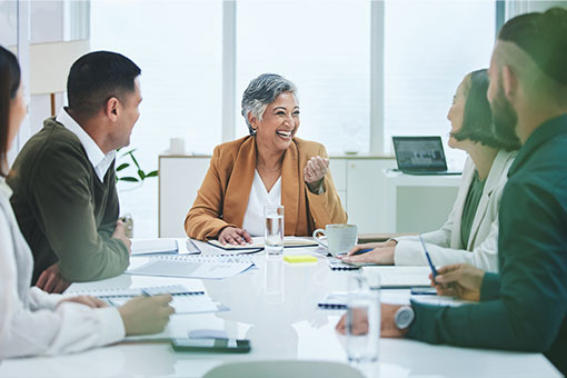 Older women holding board meeting