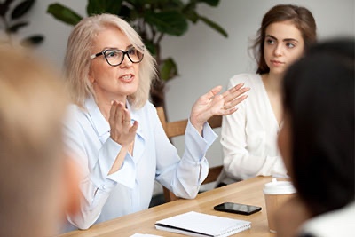 Older woman leading meeting